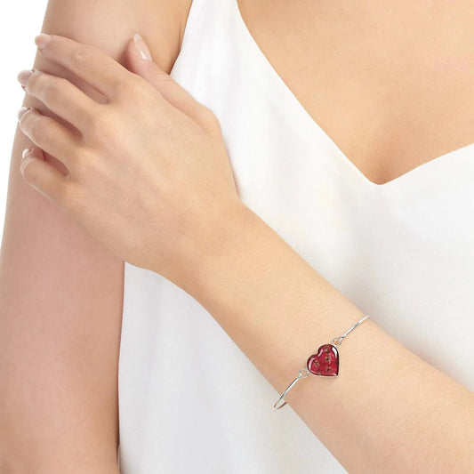 Poppy bangle with real flowers by  Shrieking Violet® Sterling silver heart bangle with tiny Euphorbia flowers. Includes giftbox.